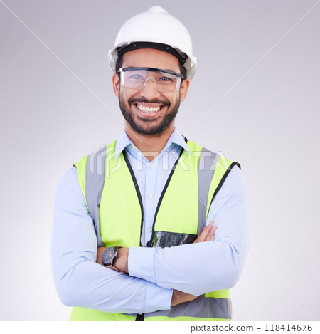 Construction worker in portrait, man with crossed arms and smile, architect or engineer in building industry on studio background. Happy contractor, professional builder with helmet and goggles Construction worker in portrait, man with crossed arms and smile, architect or engineer in building industry on studio background. Happy contractor, professional builder with helmet and goggles 118414676