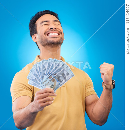 Money, studio and man excited, cheers and smile for dollar bills, financial achievement award or bonus prize. Cash, competition winner and person happy for income, revenue or pay on blue background Money, studio and man excited, cheers and smile for dollar bills, financial achievement award or bonus prize. Cash, competition winner and person happy for income, revenue or pay on blue background 118414697