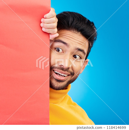 Surprise, peeking and young man in studio with a wow, omg or wtf facial expression by a board with mockup. Happy, shock and male model with sneaky face by poster with mock up space by blue background Surprise, peeking and young man in studio with a wow, omg or wtf facial expression by a board with mockup. Happy, shock and male model with sneaky face by poster with mock up space by blue background 118414699