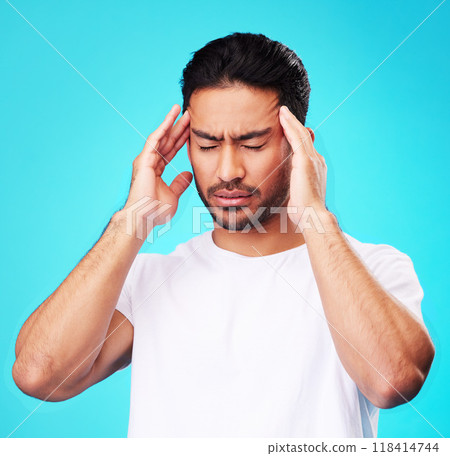 Stress, pain and man with a headache, burnout and health problem on a blue studio background. Male person, anxiety and model with a migraine, frustrated and tension with strain, fatigue and pressure 118414744