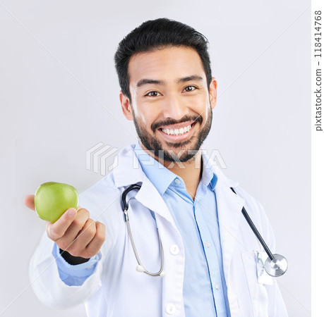 Doctor, man and apple in portrait, happy with health and nutritionist isolated on studio background. Medical professional, male physician with smile and healthcare, promote healthy diet and nutrition 118414768