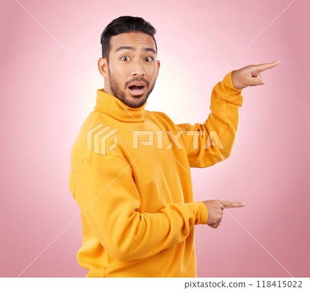 Surprise, pointing and wow with portrait of man in studio for show, announcement and deal. News, advertising and idea with person on pink background for promotion, information and solution mockup 118415022