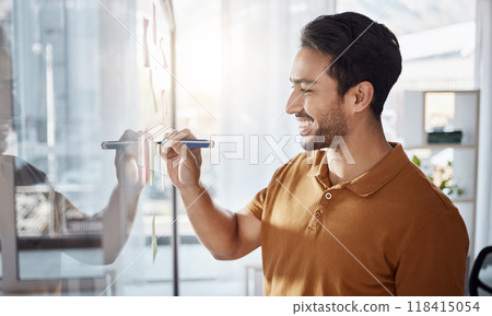 Happy man writing on glass for ideas, planning and project management goals or business schedule in office startup. Young, creative Asian person brainstorming on window for solution or development Happy man writing on glass for ideas, planning and project management goals or business schedule in office startup. Young, creative Asian person brainstorming on window for solution or development 118415054