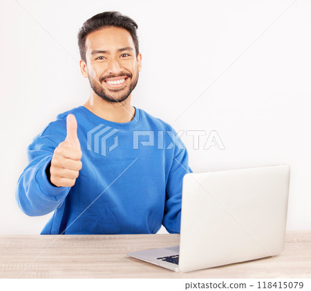 Portrait, laptop and thumbs up with an IT support man at his desk in studio on a white background. Smile, thank you and yes with a happy male computer engineer working to finish or complete a task 118415079