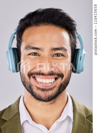 Face, headphones and smile of business man in studio isolated on a gray background. Portrait, entrepreneur and happy Asian male streaming, listening or enjoying music, podcast or radio, song or album Face, headphones and smile of business man in studio isolated on a gray background. Portrait, entrepreneur and happy Asian male streaming, listening or enjoying music, podcast or radio, song or album 118415659