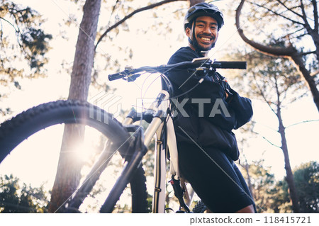 Forest, fitness and portrait of cyclist with bicycle in nature with smile, adventure trail and health from below. Cycling, woods and man with mountain bike in trees for workout, motivation or energy. 118415721