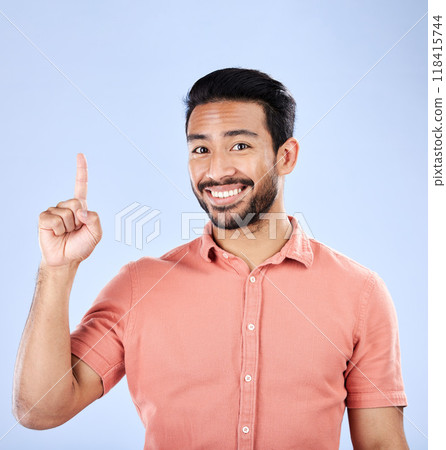 Happy, portrait and man pointing in a studio to mockup space for advertising, marketing or product placement. Happiness, smile and male model showing mock up while isolated by a purple background. Happy, portrait and man pointing in a studio to mockup space for advertising, marketing or product placement. Happiness, smile and male model showing mock up while isolated by a purple background. 118415744
