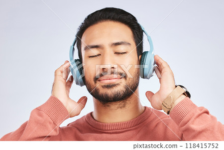 Man, headphones and calm music in studio, white background and podcast for peace. Face of happy young asian male model listening to audio, streaming sound and hearing radio to relax with song in mind Man, headphones and calm music in studio, white background and podcast for peace. Face of happy young asian male model listening to audio, streaming sound and hearing radio to relax with song in mind 118415752