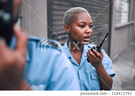 Security, walkie talkie and a police woman in the city during her patrol for safety or law enforcement. Radio, communication and service with an african female guard on a street in an urban town 118415793