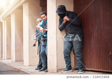 Police, criminal and gun taking cover for security, backup or law enforcement outside house. Man, woman cop and dangerous robber with weapon in crime for justice, investigation or protection service 118415808