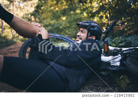 Man, cycling injury and leg or knee pain outdoor on mountain bike in nature. Athlete person on forest ground for fitness exercise or training workout accident, crash or fall with helmet and bicycle 118415981