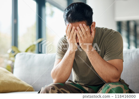 Military, army and a man with trauma and depression while sitting on a sofa with mental health or stress. Soldier, psychology and a male person with anxiety, fear and frustration or ptsd crisis 118416000