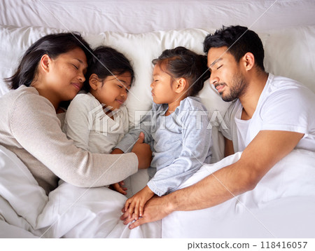Relax, love and family sleeping in a bed from above, peaceful and dreaming in their home. Sleep, peace and top view of children with parents in a bedroom, tired and resting together on the weekend Relax, love and family sleeping in a bed from above, peaceful and dreaming in their home. Sleep, peace and top view of children with parents in a bedroom, tired and resting together on the weekend 118416057
