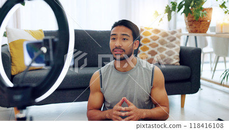 Fitness influencer man, live stream and house with smile, tutorial and training video on social media app. Asian personal trainer, ring light and web blog for workout, exercise or wellness for advice 118416108