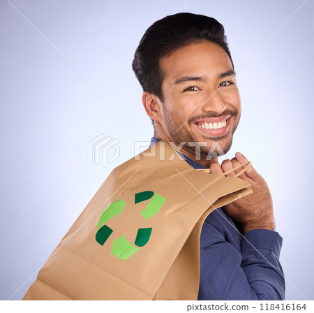 Man in portrait, happy and recycling paper bag, environment and sustainable shopping on studio background. Eco friendly, green and climate change awareness in retail, sustainability and recycle logo Man in portrait, happy and recycling paper bag, environment and sustainable shopping on studio background. Eco friendly, green and climate change awareness in retail, sustainability and recycle logo 118416164