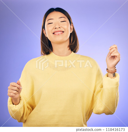 Happy asian woman, dancing and music in freedom or casual fashion against a purple studio background. Female person or model smile enjoying energy, event or party in happiness for clothing style Happy asian woman, dancing and music in freedom or casual fashion against a purple studio background. Female person or model smile enjoying energy, event or party in happiness for clothing style 118416173