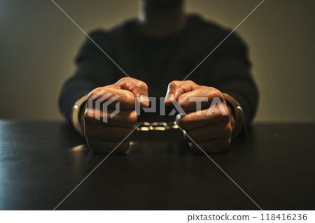 Interrogation, jail and hands of criminal in handcuffs for interview, investigation and arrested in station. Security, law and closeup of man, burglar or thief for crime, stealing and theft in prison 118416236