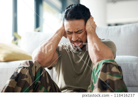 Soldier, man and stress, headache or PTSD of military trauma, remember pain and fear or scared on floor. Sad, frustrated and mental health of army or veteran person with depression or anxiety at home 118416237
