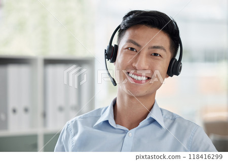 Asian man, call center and portrait smile with headphones in customer service, telemarketing or support at office. Face of happy male person or consultant agent smiling for online advice at workplace Asian man, call center and portrait smile with headphones in customer service, telemarketing or support at office. Face of happy male person or consultant agent smiling for online advice at workplace 118416299