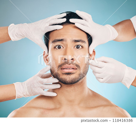 Portrait, hands and plastic surgery with a nervous man in studio on a blue background for beauty enhancement. Face and change with a young male patient looking worried in a clinic for skincare Portrait, hands and plastic surgery with a nervous man in studio on a blue background for beauty enhancement. Face and change with a young male patient looking worried in a clinic for skincare 118416386