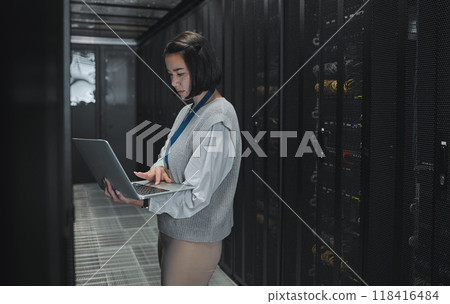Server room, laptop and technician woman for data center management, system update and cyber security. Focus, serious and inspection of asian electrician, engineering or programmer person typing code 118416484