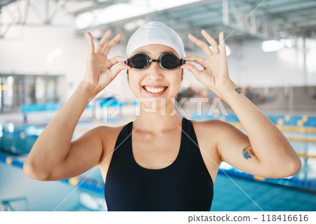 Professional swimming, portrait of happy woman with goggles at pool for exercise, wellness and winner mindset. Water sports, workout and champion swimmer at swim competition with smile and happiness. Professional swimming, portrait of happy woman with goggles at pool for exercise, wellness and winner mindset. Water sports, workout and champion swimmer at swim competition with smile and happiness. 118416616