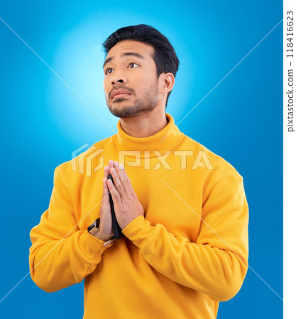 Peace, man with hand gesture and praying against a blue background for worship. Thank you or faith, spiritual growth or meditation and young male person with emoji hands sign for religion in studio Peace, man with hand gesture and praying against a blue background for worship. Thank you or faith, spiritual growth or meditation and young male person with emoji hands sign for religion in studio 118416623