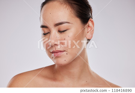 Skincare, face and beauty of a woman in studio for cosmetic, dermatology and makeup shine. Aesthetic asian model person with wellness glow, mole on skin and luxury facial self care on grey background 118416890
