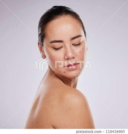 Beauty, skincare and face of a woman in studio for cosmetics, dermatology and makeup for skin glow. Aesthetic asian model person with shine, mole and luxury facial self care for health and wellness Beauty, skincare and face of a woman in studio for cosmetics, dermatology and makeup for skin glow. Aesthetic asian model person with shine, mole and luxury facial self care for health and wellness 118416905