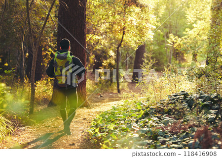 Hiker, backpacker and hiking in nature forest, trekking woods or trees for adventure, relax workout or fitness exercise. Behind man, walking or person in environment, travel or morning wellness Hiker, backpacker and hiking in nature forest, trekking woods or trees for adventure, relax workout or fitness exercise. Behind man, walking or person in environment, travel or morning wellness 118416908