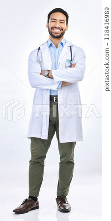 Happy man, portrait and doctor in a studio with confidence ready for work. Isolated, white background and arms crossed of a proud surgeon with happiness from healthcare, wellness and hospital job Happy man, portrait and doctor in a studio with confidence ready for work. Isolated, white background and arms crossed of a proud surgeon with happiness from healthcare, wellness and hospital job 118416989