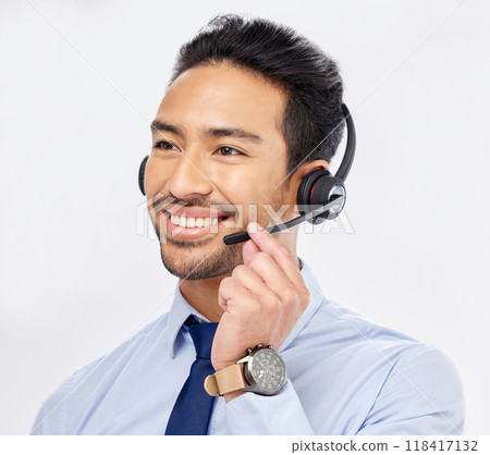 Call center, happy and Asian man with microphone for telemarketing, crm support and isolated on a white studio background. Thinking, smile and sales agent or consultant listening for customer service Call center, happy and Asian man with microphone for telemarketing, crm support and isolated on a white studio background. Thinking, smile and sales agent or consultant listening for customer service 118417132