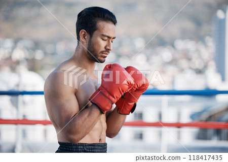 Fitness, boxer praying or man fighting in a ring on rooftop in city for combat training or meditation. Eyes closed, Muay Thai athlete or Asian mma fighter ready for workout, exercise or match battle Fitness, boxer praying or man fighting in a ring on rooftop in city for combat training or meditation. Eyes closed, Muay Thai athlete or Asian mma fighter ready for workout, exercise or match battle 118417435