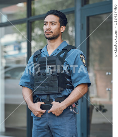 Security, police officer and man in uniform in city for defense, inspection and supervision on patrol. Surveillance, law enforcement and male person in town for safety, crime and protection service 118417460