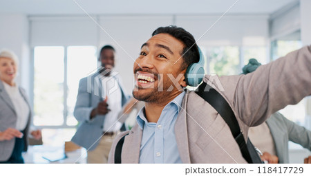 Music, dance and motivation with a businessman walking in an office while feeling positive or carefree. Success, happy or smile with a male employee arriving at work in headphones with audio Music, dance and motivation with a businessman walking in an office while feeling positive or carefree. Success, happy or smile with a male employee arriving at work in headphones with audio 118417729