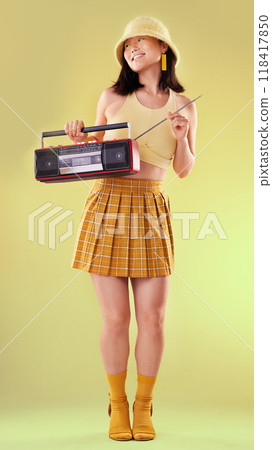 Radio, vintage and Asian woman with stereo, fashion and lady with trendy outfit against studio background. Japan, female or happy lady with freedom, music or old school style with confidence or retro Radio, vintage and Asian woman with stereo, fashion and lady with trendy outfit against studio background. Japan, female or happy lady with freedom, music or old school style with confidence or retro 118417850