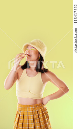 Pizza, lunch and eating woman with food while isolated on a yellow background in a studio. Hungry, dinner and Asian girl enjoying a snack, take away or unhealthy meal with mockup on a backdrop Pizza, lunch and eating woman with food while isolated on a yellow background in a studio. Hungry, dinner and Asian girl enjoying a snack, take away or unhealthy meal with mockup on a backdrop 118417862