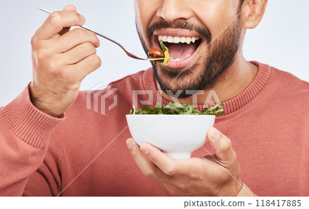 Health studio, man and mouth eating salad, vegetables or green food product for weight loss, healthy lifestyle or nutrition. Closeup nutritionist, lettuce bowl and hungry person on white background Health studio, man and mouth eating salad, vegetables or green food product for weight loss, healthy lifestyle or nutrition. Closeup nutritionist, lettuce bowl and hungry person on white background 118417885
