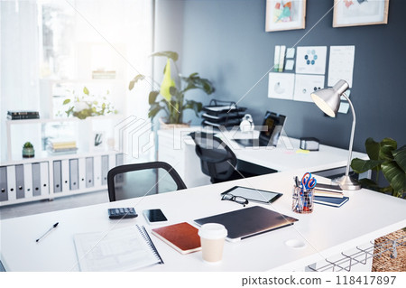 Empty office, interior and business with table, professional layout and desk in startup agency. Background of modern workplace, building and furniture in company, workspace and setup in bright room Empty office, interior and business with table, professional layout and desk in startup agency. Background of modern workplace, building and furniture in company, workspace and setup in bright room 118417897