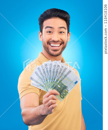 Happy man, portrait and money fan for bonus offer, financial success and winning, finance loan or cashback bonus. Young asian person or winner notes or cash profit isolated on studio blue background Happy man, portrait and money fan for bonus offer, financial success and winning, finance loan or cashback bonus. Young asian person or winner notes or cash profit isolated on studio blue background 118418106
