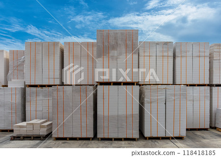 Pile of Lightweight Concrete bricks, Packages of blocks on pallets put on an outdoor warehouse. 118418185