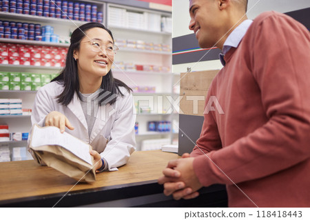 Pharmacy, paper bag and pharmacist woman for customer service, medical support or retail product help desk. Asian advice, pharmaceutical drugs and healthcare receipt for black man, client or patient Pharmacy, paper bag and pharmacist woman for customer service, medical support or retail product help desk. Asian advice, pharmaceutical drugs and healthcare receipt for black man, client or patient 118418443