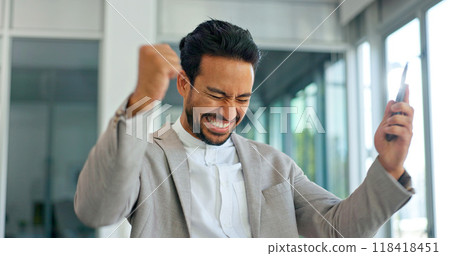 Celebrate, excited and phone of business man in office for good news or yes feedback. Success, winning and fist of asian male employee with smartphone for wow achievement, promotion or online bonus 118418451