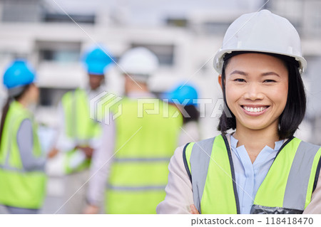 Engineering, leadership and portrait of a woman construction worker on an outdoor site. Confidence, happy and Asian female industry manager or foreman standing with crossed arms on a building plot. 118418470