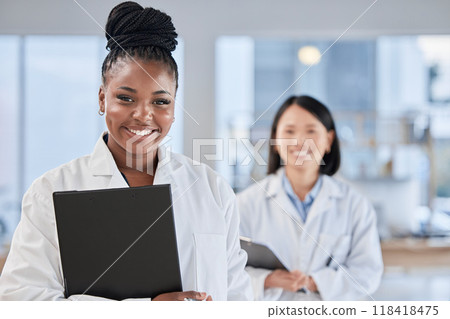 Doctor black woman, checklist and portrait with smile, planning and happy at clinic with asian expert. Medic, teamwork and clipboard for schedule, analysis and results in hospital for health vision 118418475