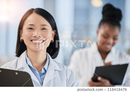 Asian doctor woman, checklist and portrait with smile, planning or happy at clinic with african expert. Medic, teamwork and clipboard for schedule, analysis or results in hospital for healthcare goal 118418476