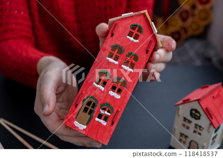 Sustainableminded Christmas cozy atmospheric festive decor in modern scandinavian home handmade decoration. Tutorial for making do it yourself craft wooden houses. Seasonal activity for kids 118418537