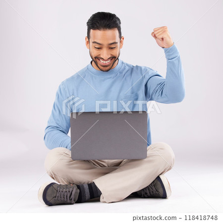 Happy, yes and success with man and laptop in studio for deal, winner and good news. Technology, internet and achievement with person and fist pump on white background for website, wow or celebration 118418748