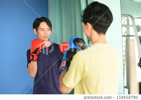 Young Asian men boxing in a gym Young Asian men boxing in a gym 118418790
