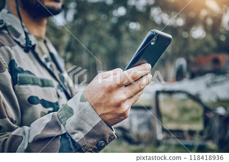 Military soldier, mobile phone and communication while outdoor for connection, safety and security. Army person with a smartphone for social media, contact or chat on a field, boot camp or at war 118418936